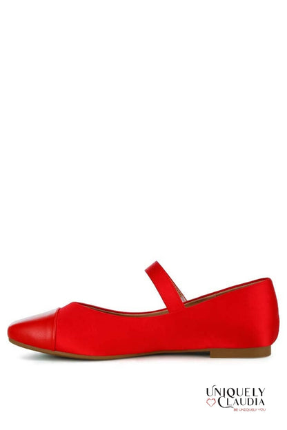 Red shoe with a brown sole on a white background