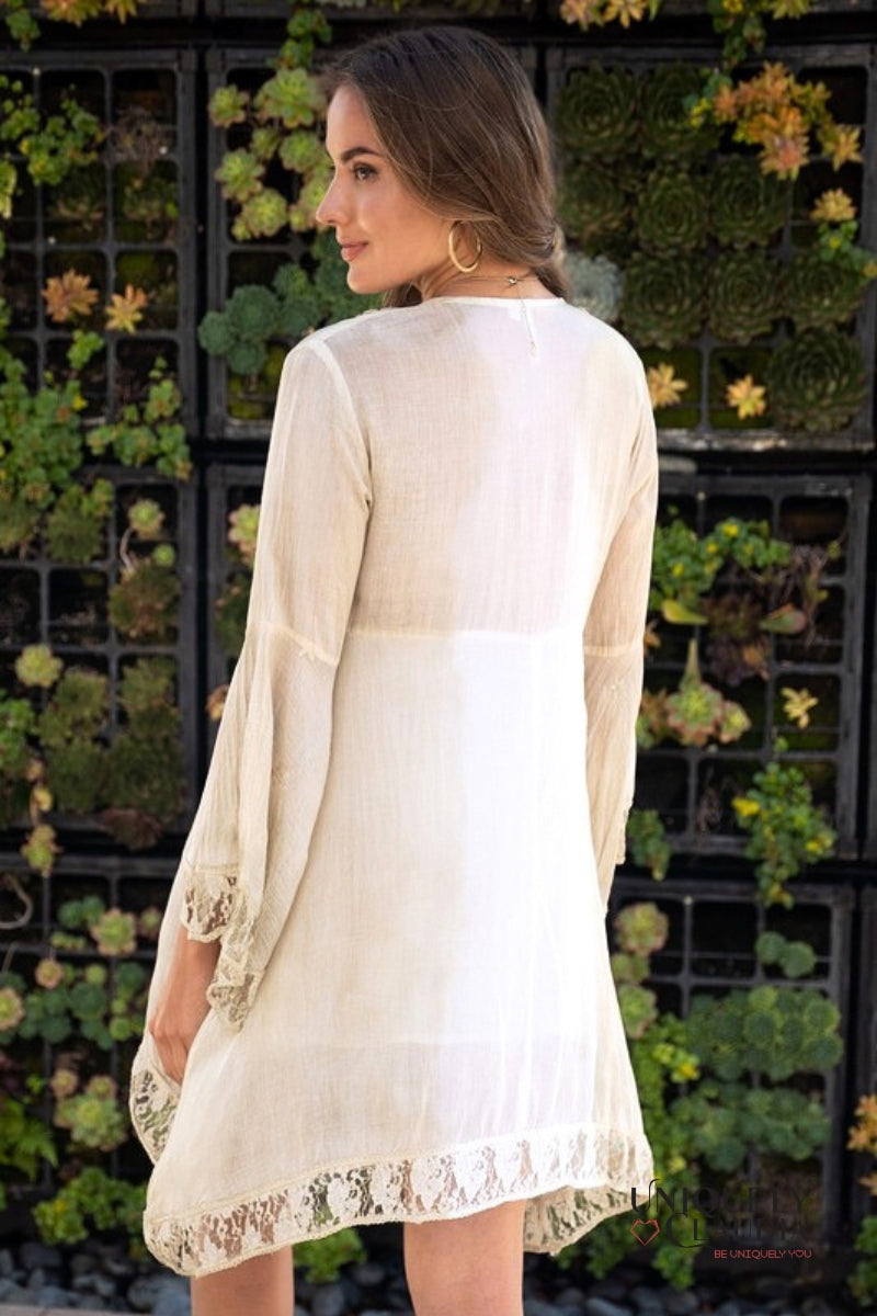 woman wearing summer dress accented with shells and lace