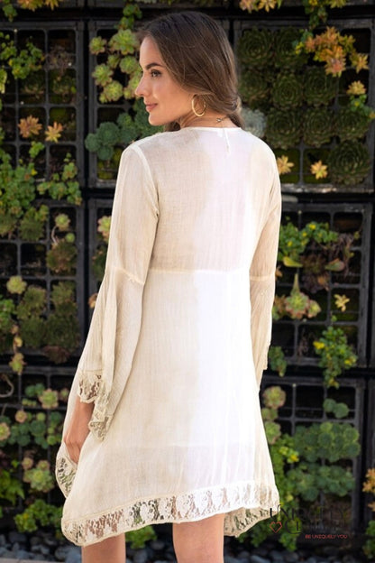 woman wearing summer dress accented with shells and lace