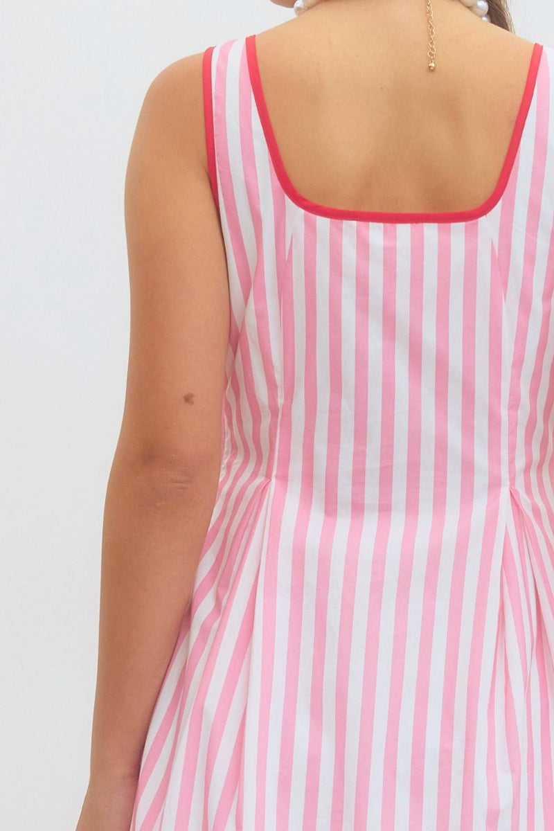 Pink and white striped dress on a plain background