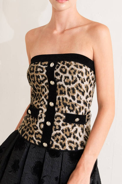 Leopard print strapless top with black buttons on a plain background