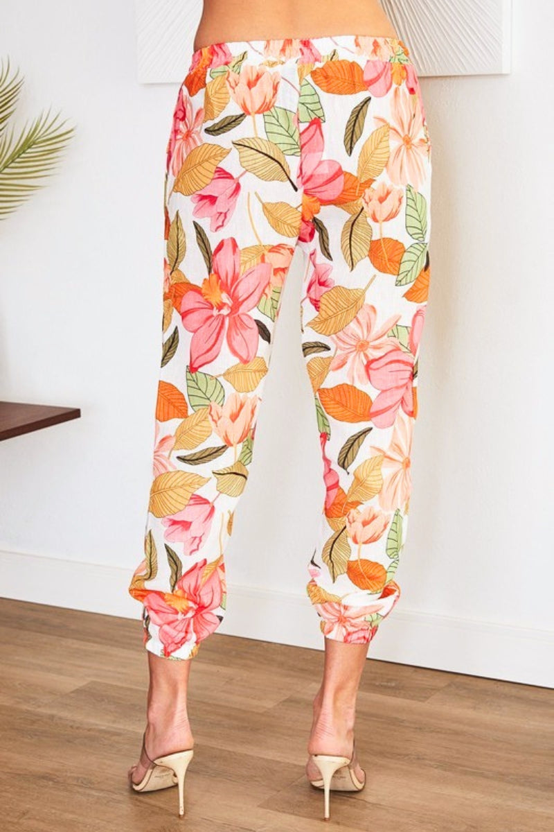 Floral pants with pink and orange flowers on a white background