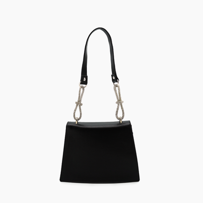 Black handbag with a decorative strap on a white background