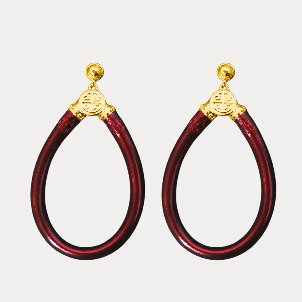Pair of merlot hoop earrings with gold accents on a light gray background