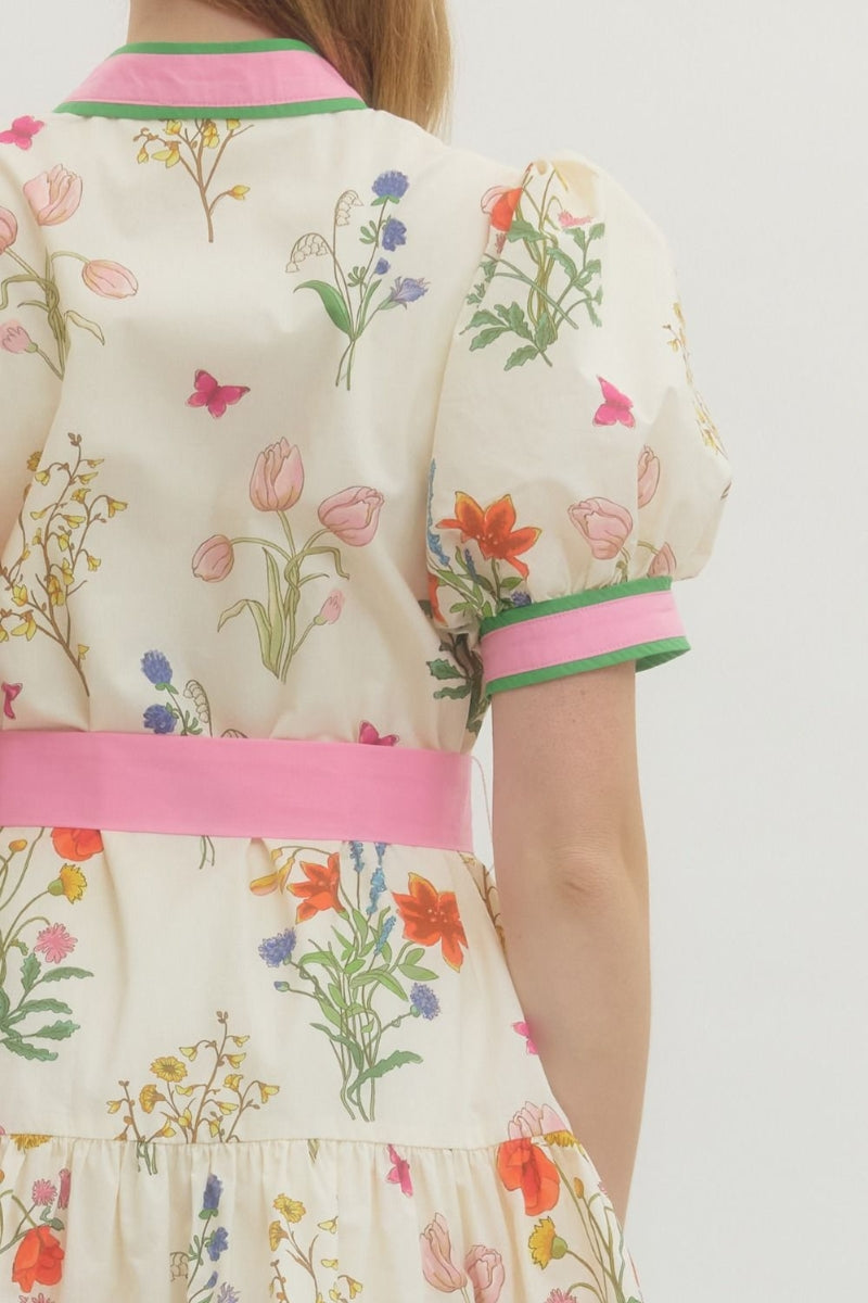 Floral dress with colorful embroidery on a plain background