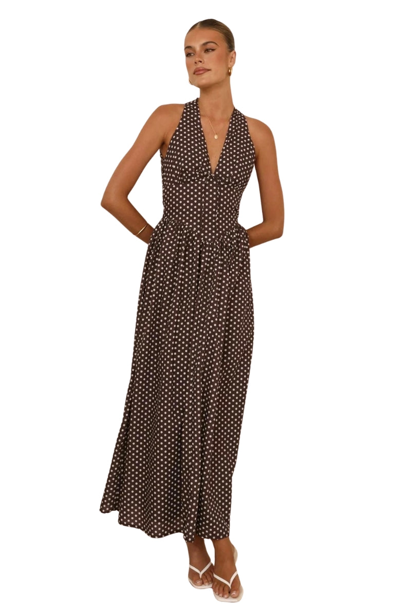 Woman wearing a polka dot dress on a white background