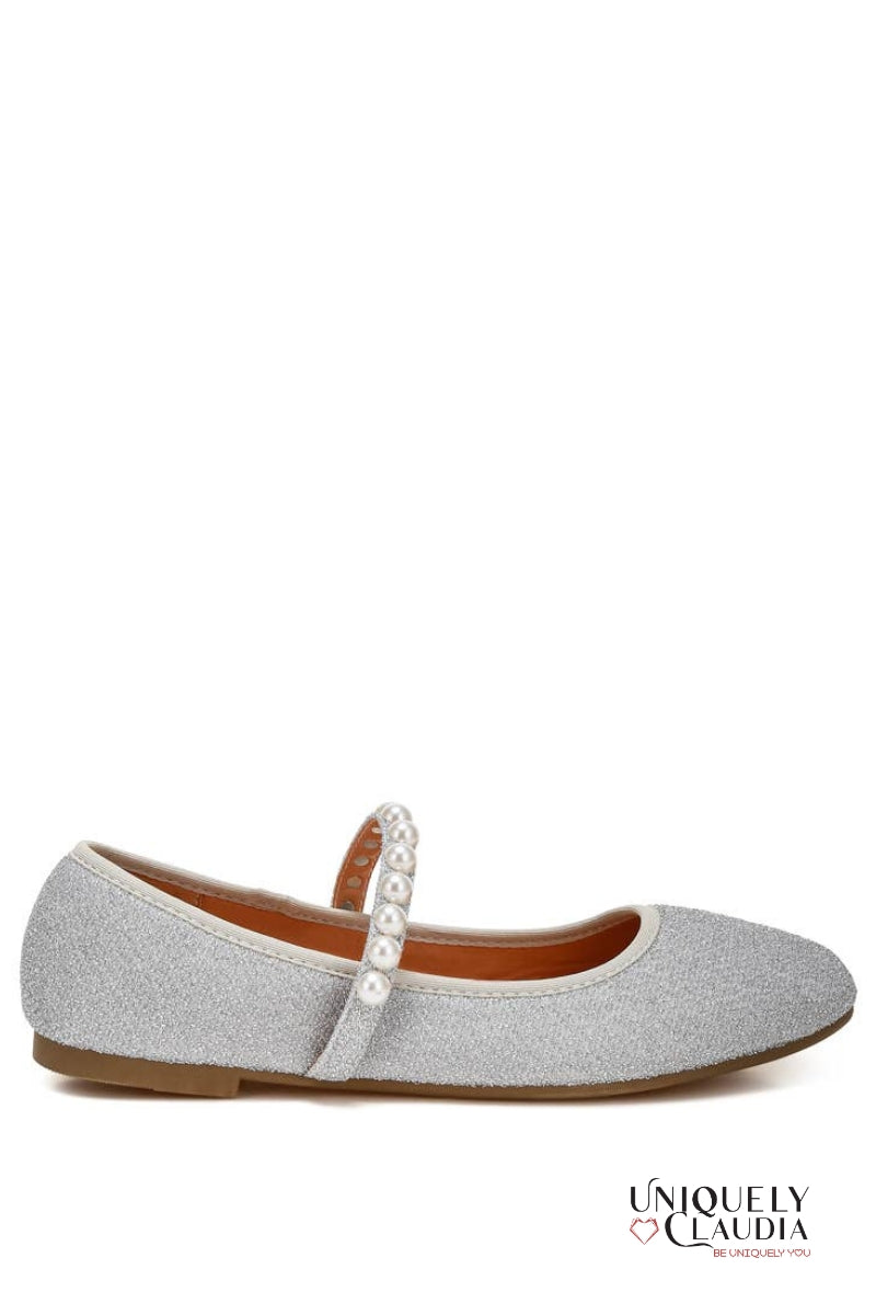 Silver glittery ballerina shoe with a strap on a white background