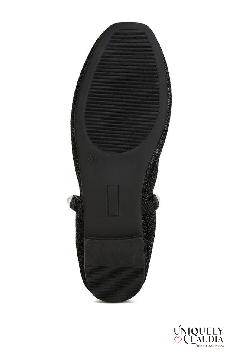Black shoe sole on a white background with 'Uniquely Claudia' branding.