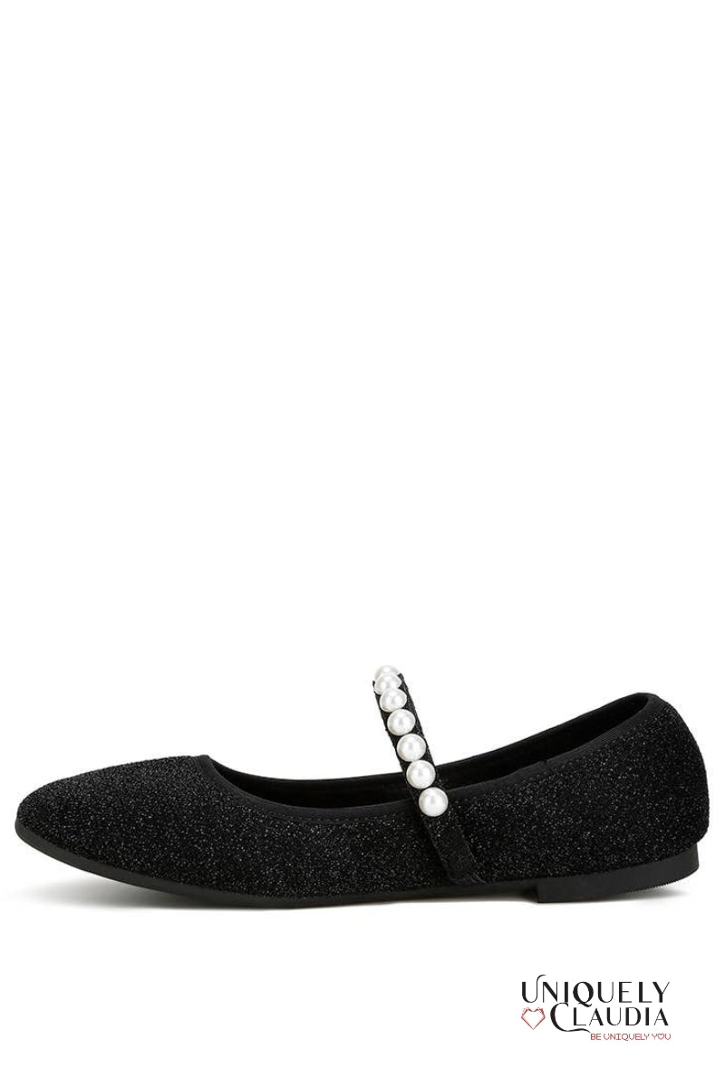 Black ballerina shoe with pearl strap on a white background