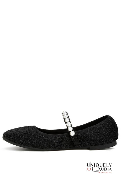 Black ballerina shoe with pearl strap on a white background