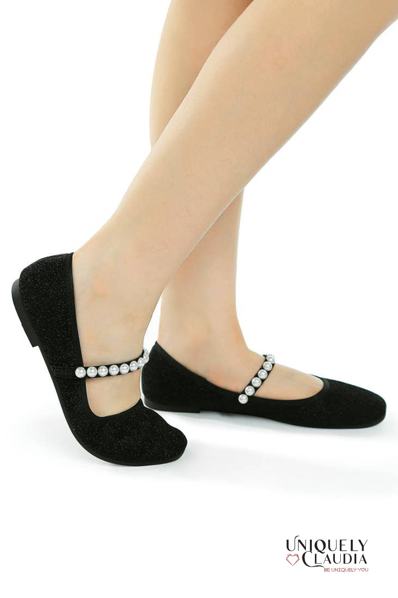 Black socks with pearl embellishments worn by a person on a white background, featuring the brand 'Uniquely Claudia'.