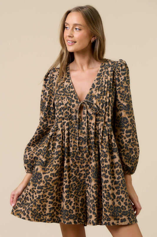 Woman wearing a leopard print romper against a beige background