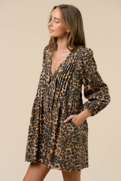 Woman wearing a leopard print romper against a beige background