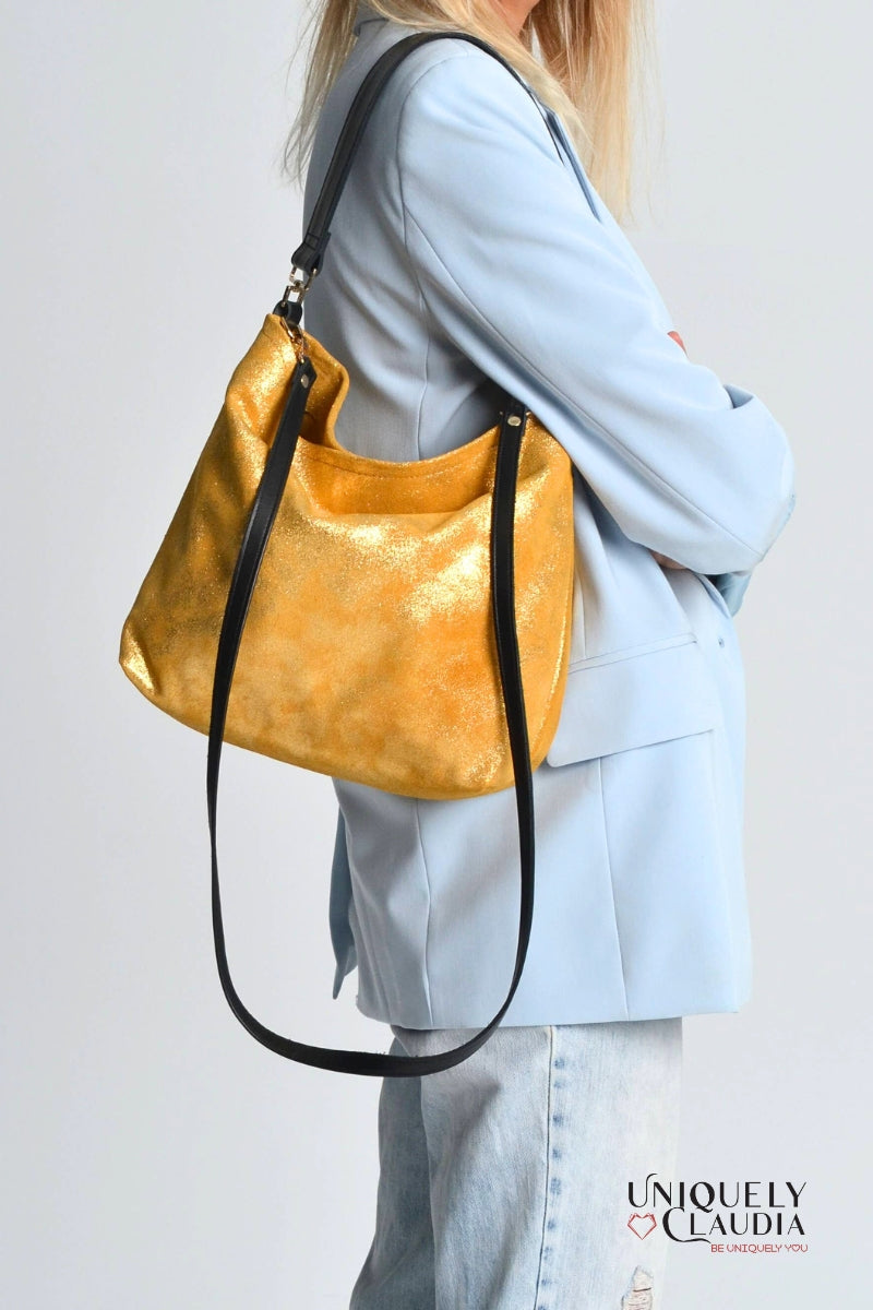 Woman holding a gold handbag 