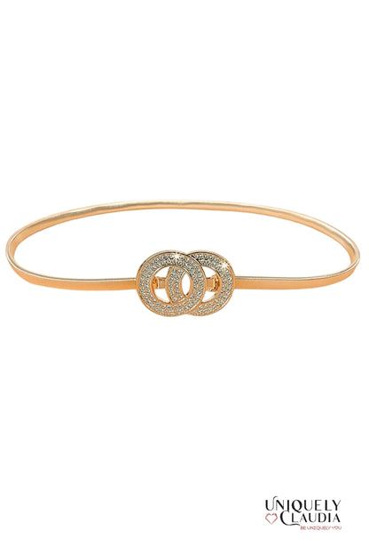 Gold belt with interlocking circular design on a white background