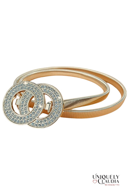 Gold belt with interlocking circular design on a white background