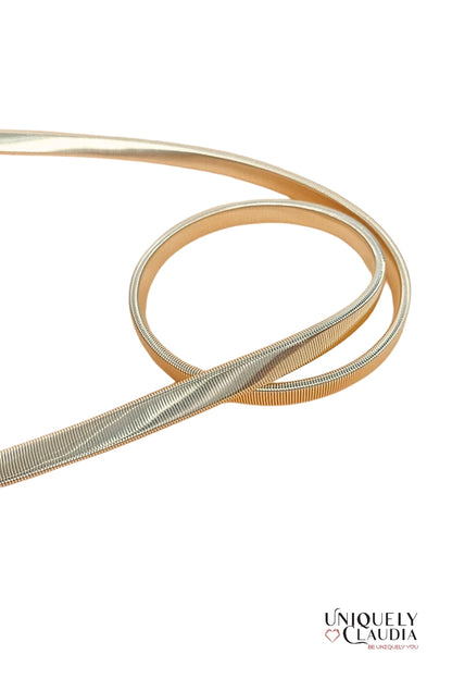 Gold belt with interlocking circular design on a white background