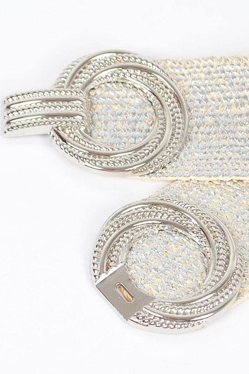 Close-up of a silver belt buckle with intricate design on a white background