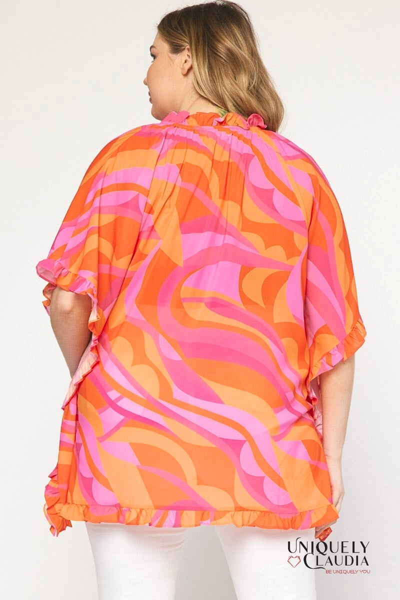 Plus size woman wearing pink and orange tunic