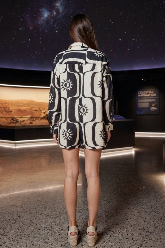 Woman wearing a patterned outfit in a space-themed exhibit