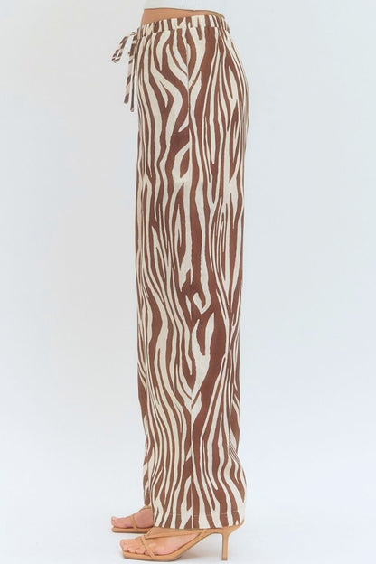Zebra print pants on a white background
