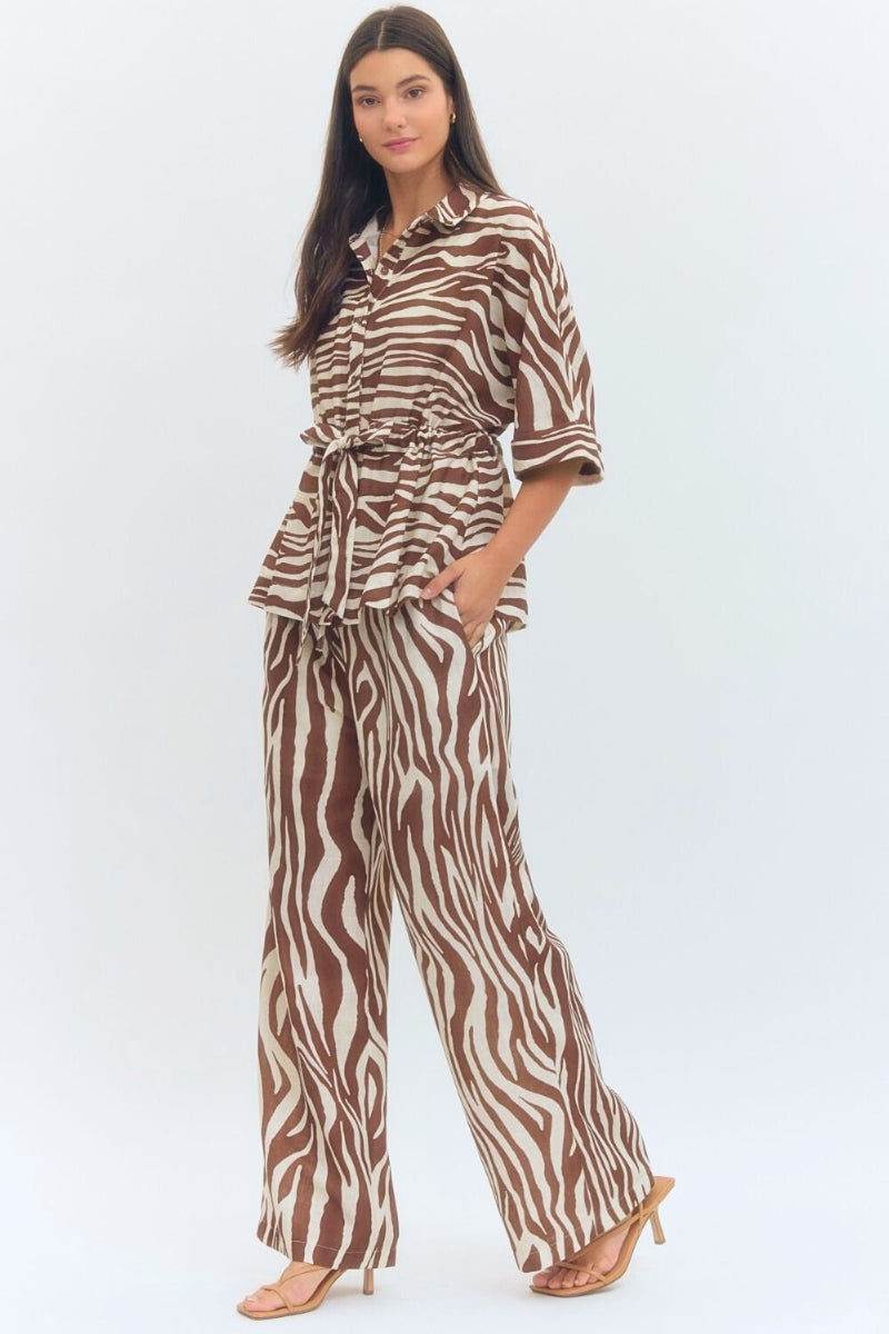 Woman wearing a zebra print outfit on a white background