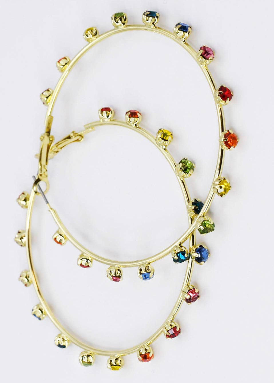 Gold hoop earrings with colorful gemstones on a white background