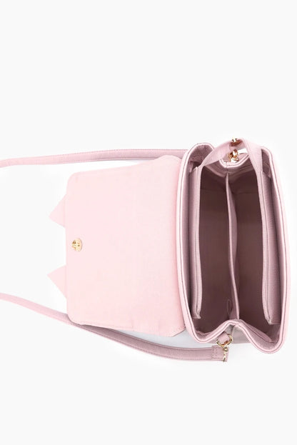 Pink handbag with a gold clasp on a white background