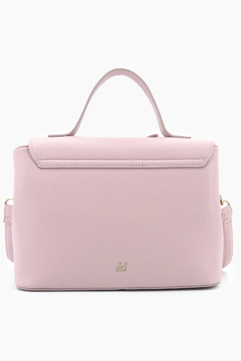 Pink handbag with a visible brand logo on a white background