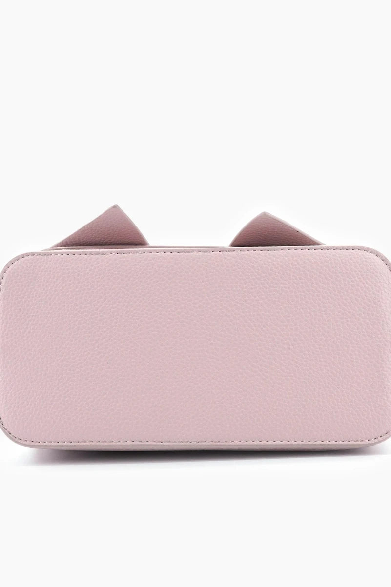 Pink wallet with bow details on a white background