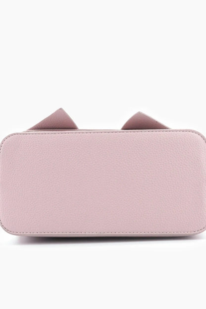 Pink wallet with bow details on a white background