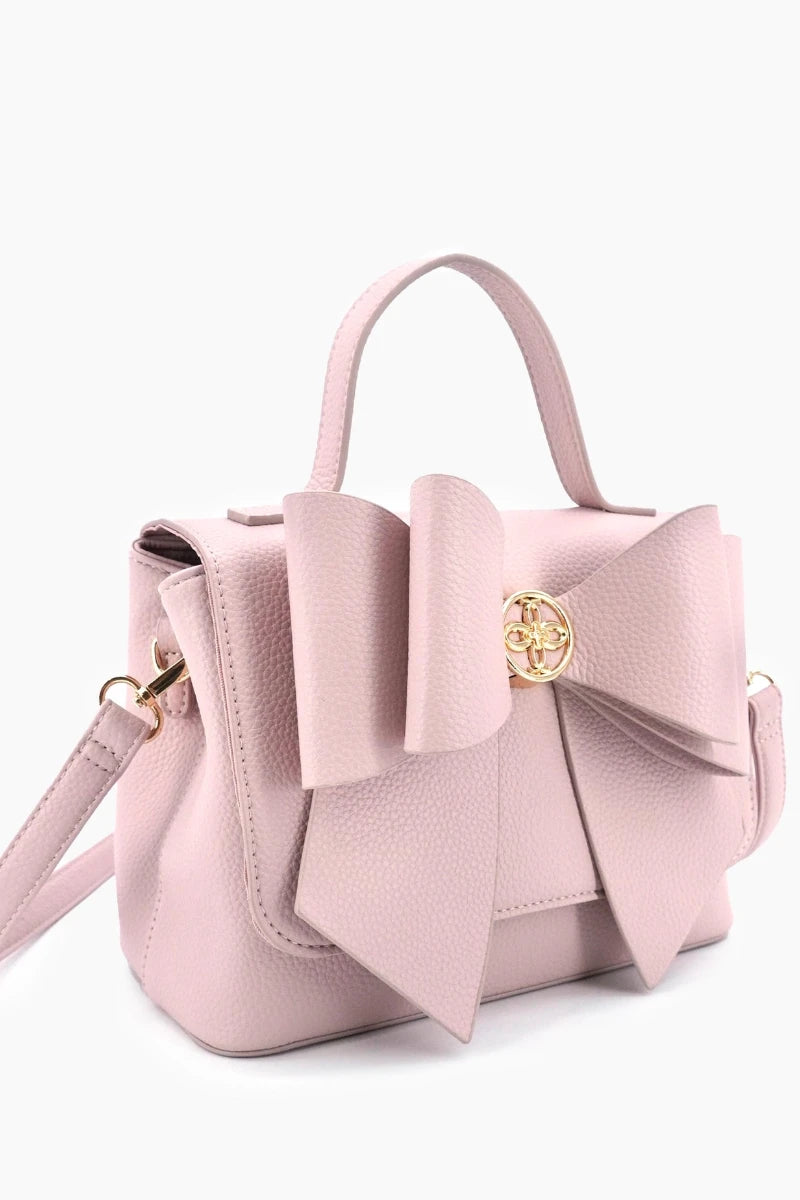 Pink handbag with a large bow on a white background