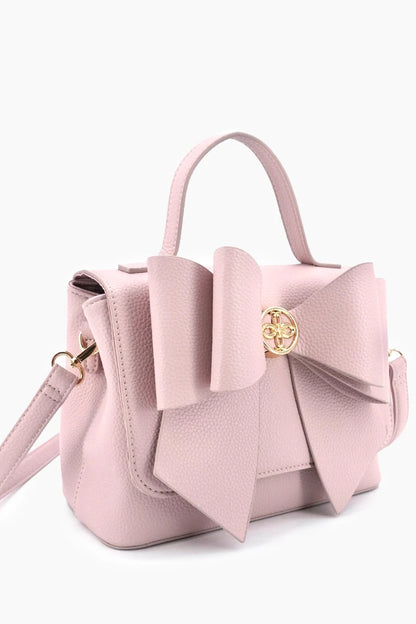 Pink handbag with a large bow on a white background