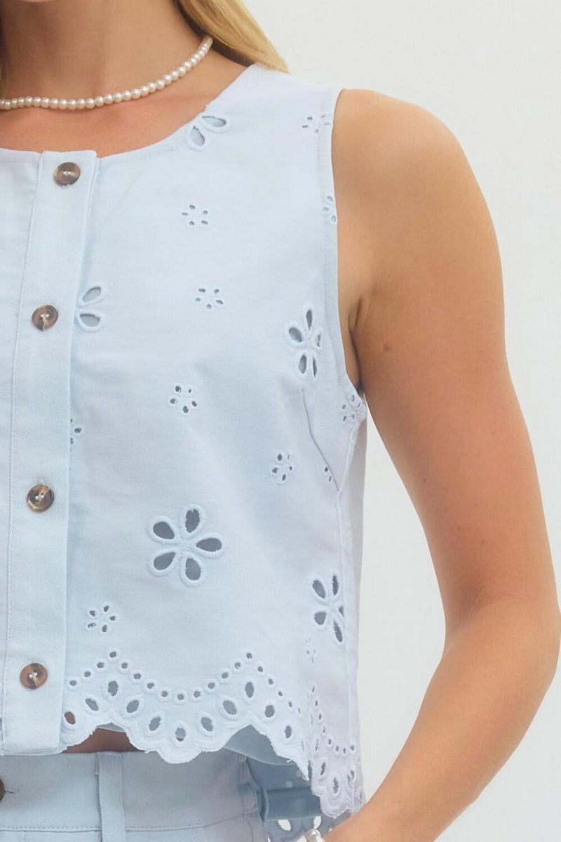 Light blue sleeveless top with floral cut-out details on a white background