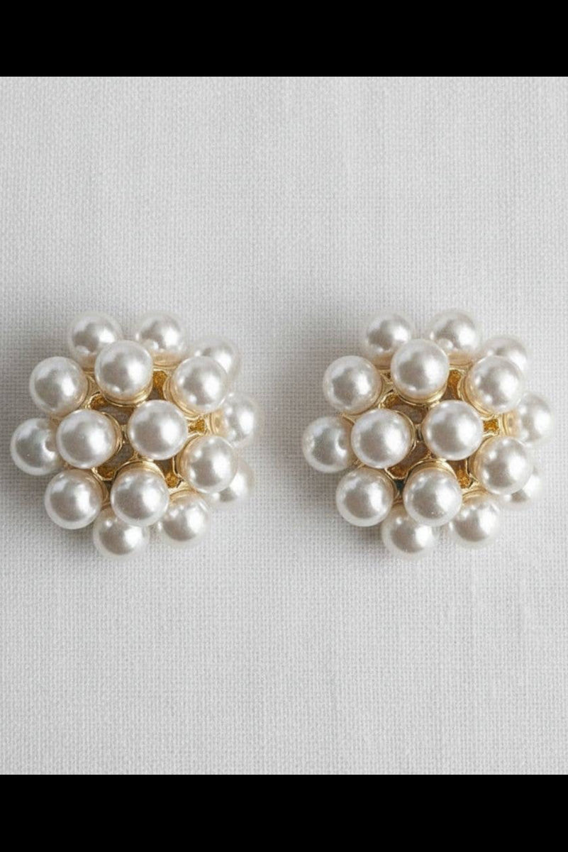 Pair of pearl earrings on a light gray background