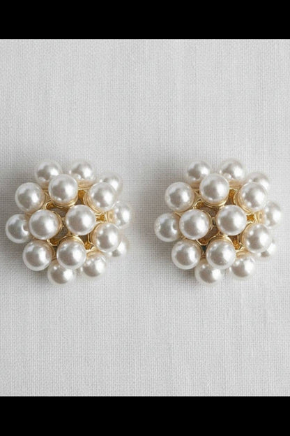 Pair of pearl earrings on a light gray background