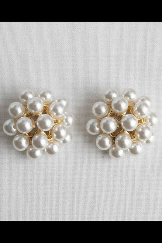 Pair of pearl earrings on a light gray background