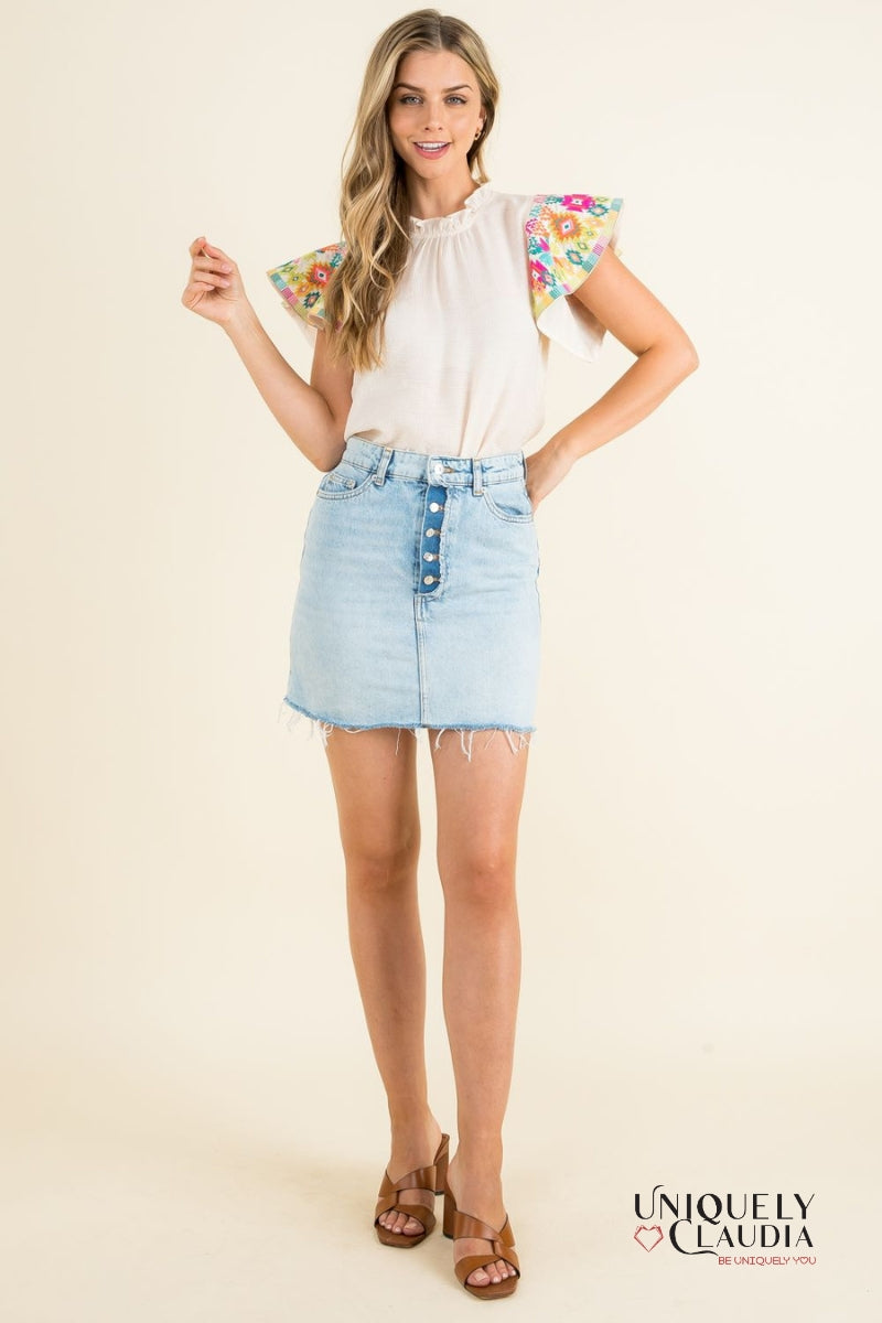 woman wearing top with colorful ruffle sleeves