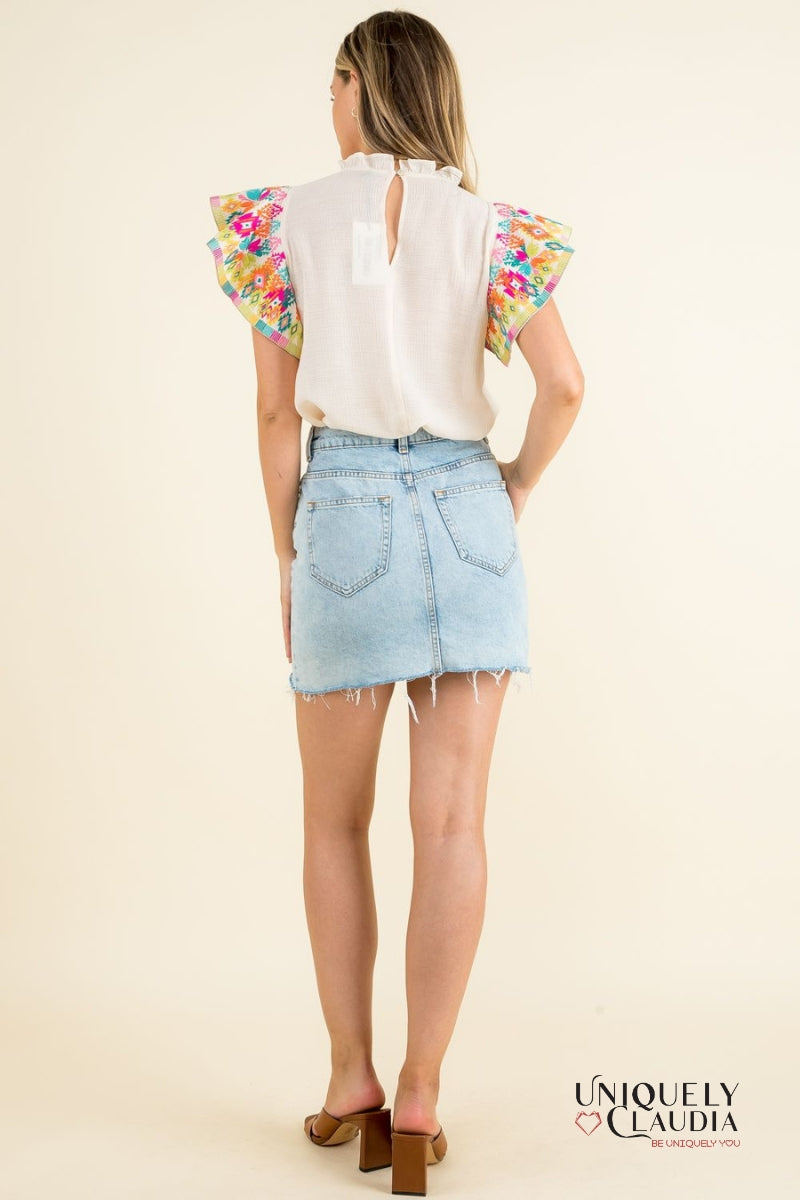 woman wearing top with colorful ruffle sleeves