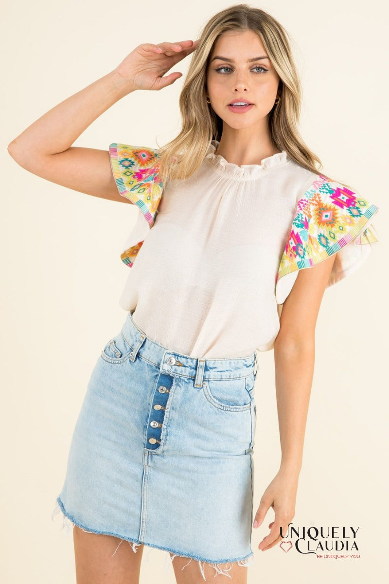 woman wearing top with colorful ruffle sleeves