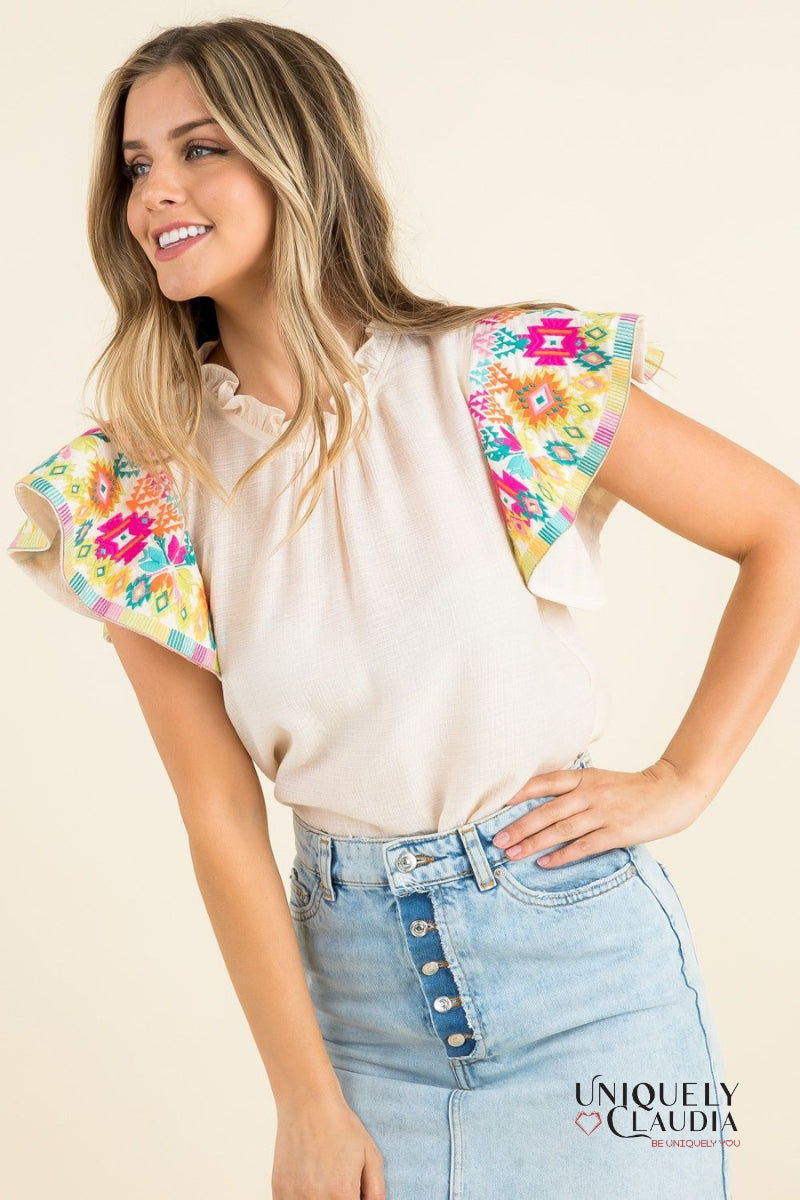 woman wearing top with colorful ruffle sleeves