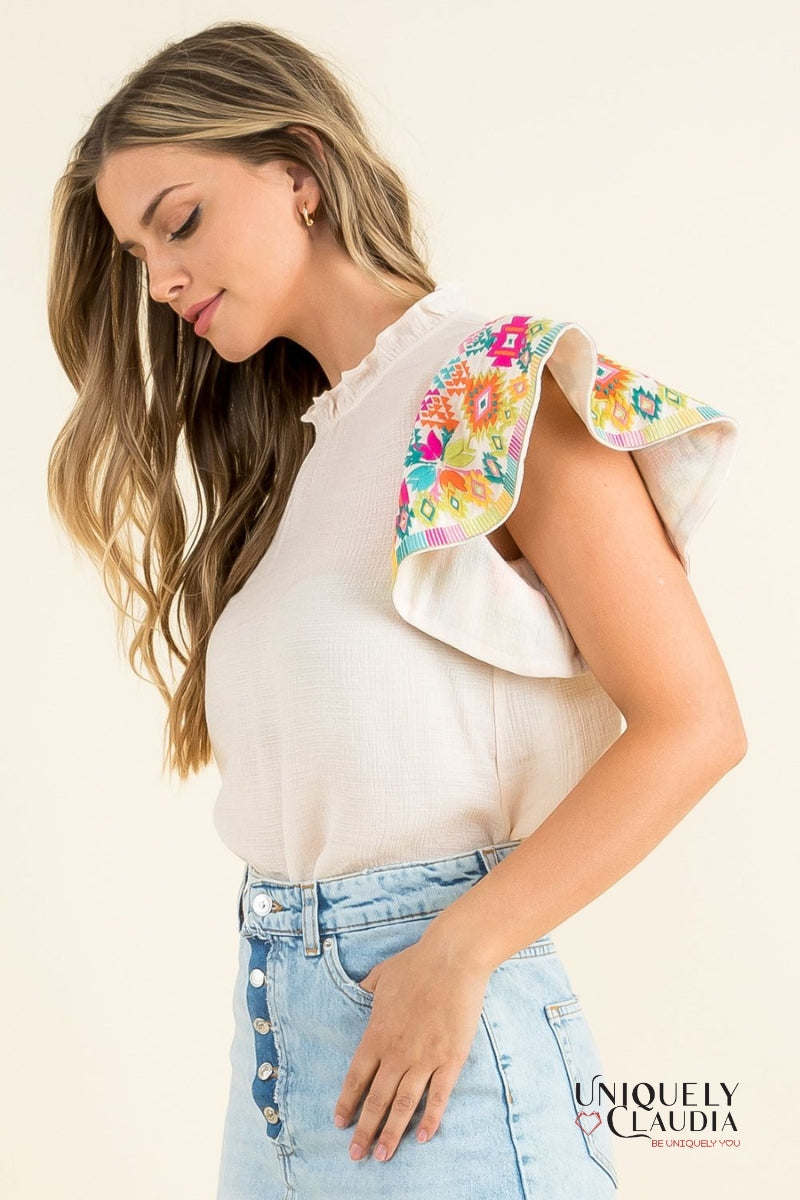 woman wearing top with colorful ruffle sleeves
