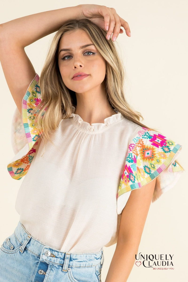 woman wearing top with colorful ruffle sleeves