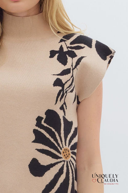 Beige sleeveless top with black floral pattern on a white background