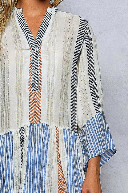 Striped dress with a mix of colors on a plain background