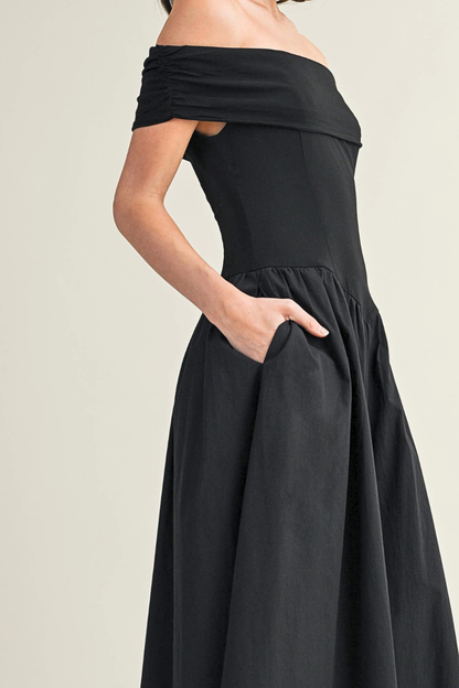 Black off-shoulder dress on a plain background