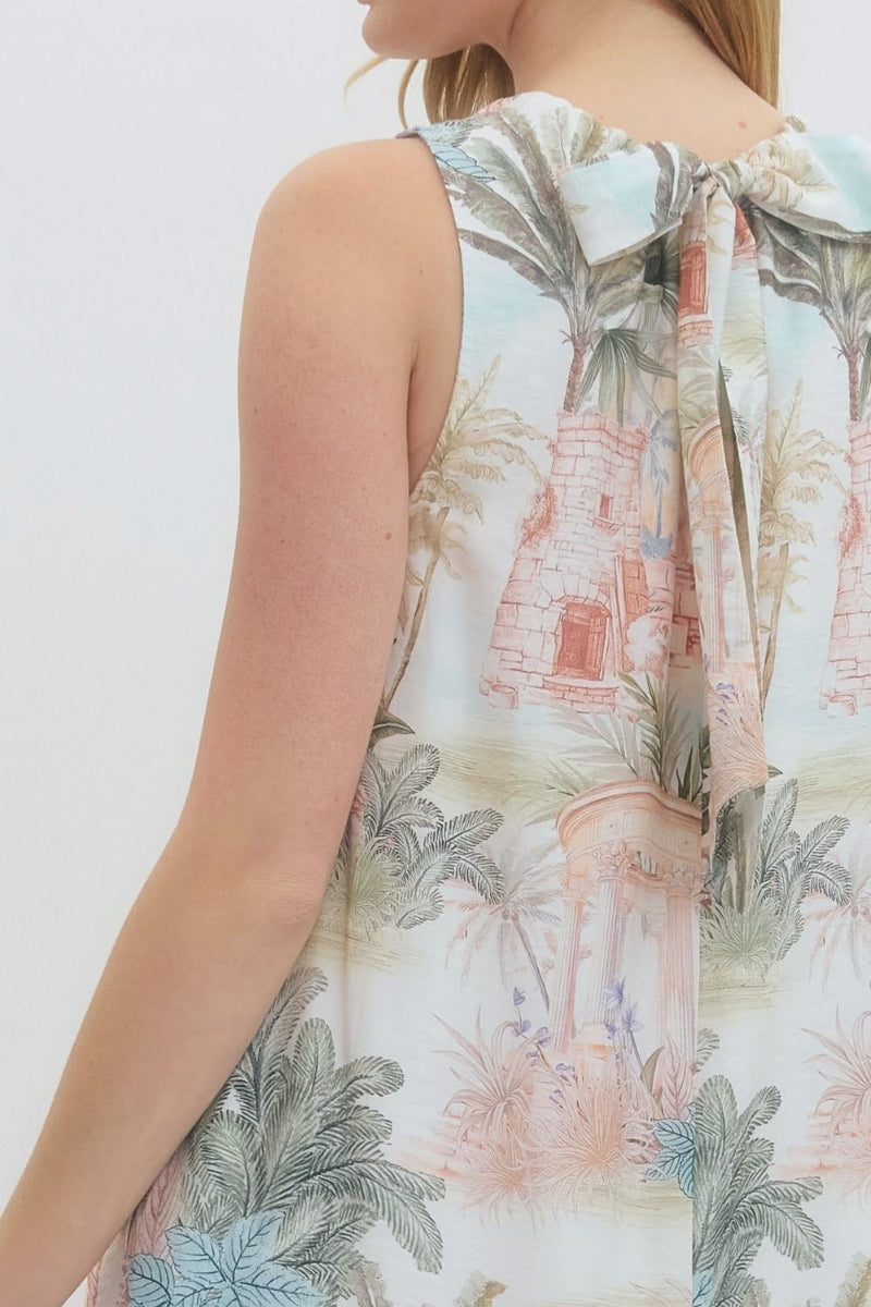 Sleeveless dress with tropical print on a plain background