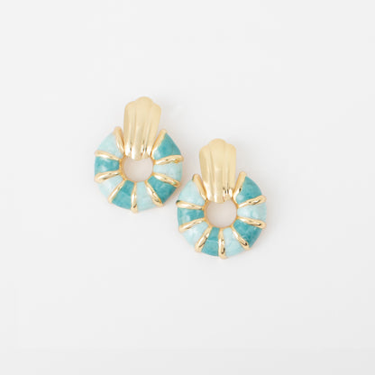 Pair of earrings with turquoise and gold design on a white background