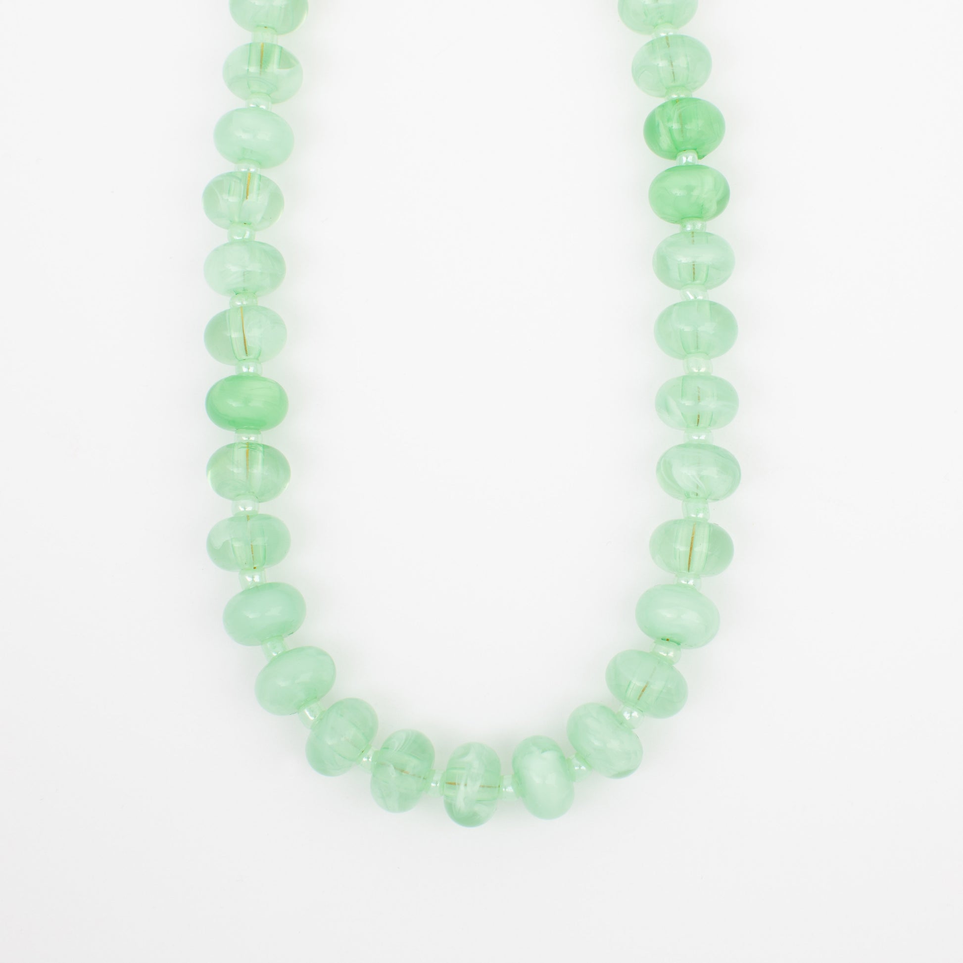 Green beaded necklace on a white background