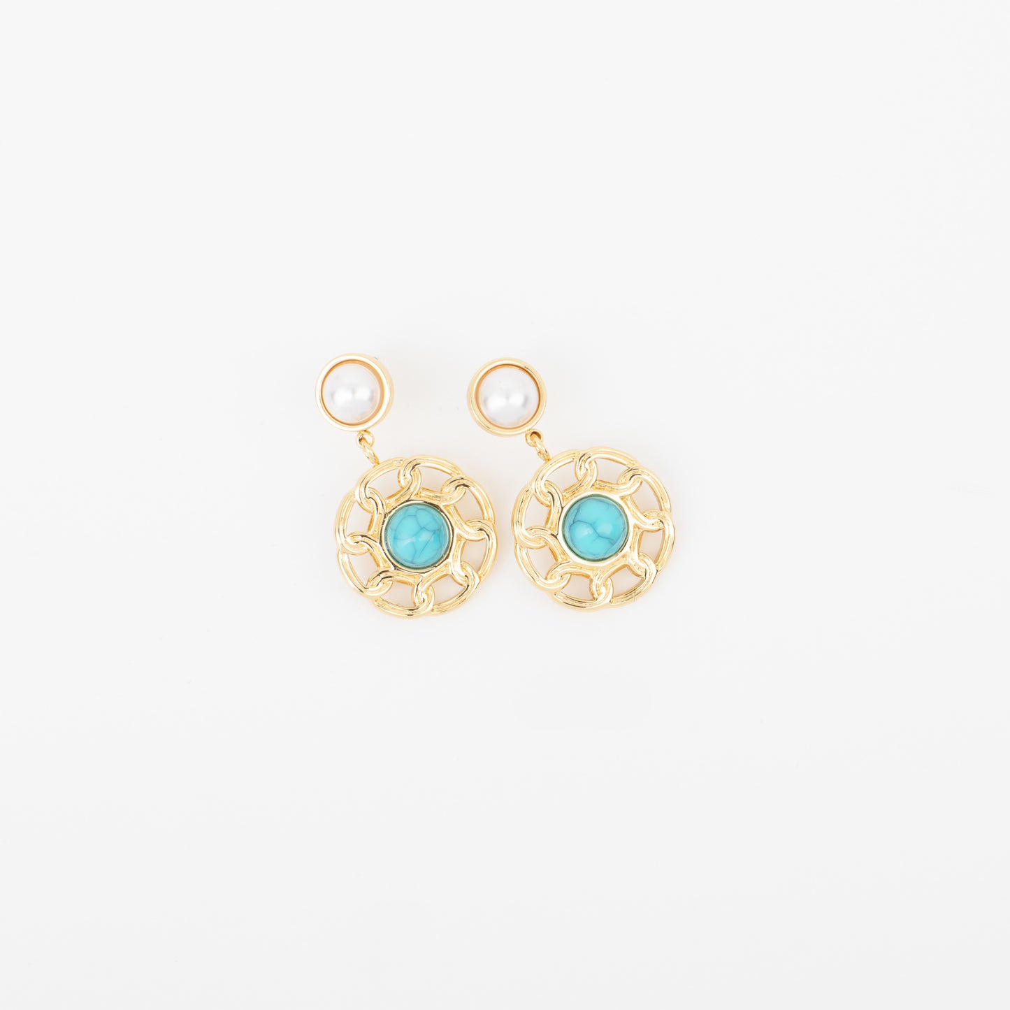 Gold earrings with turquoise stones on a white background